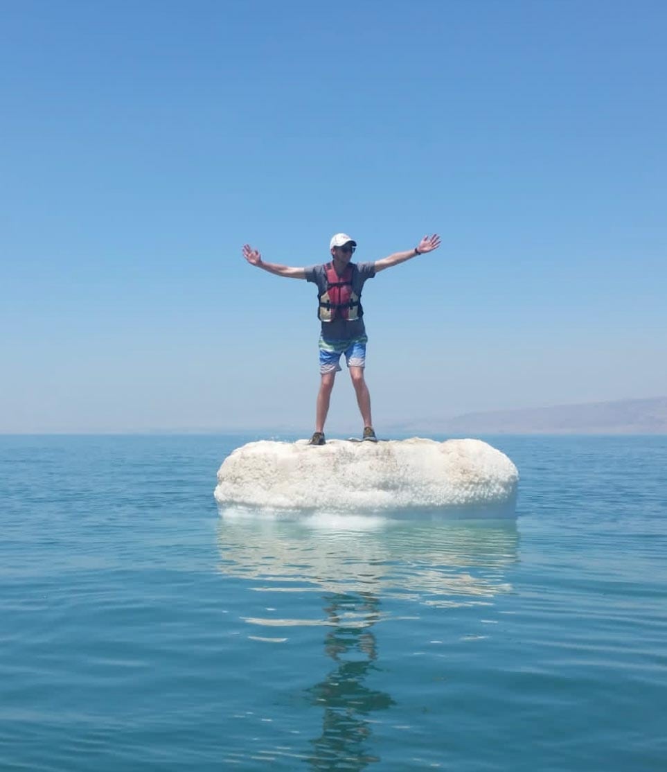 A man standing on an iceberg in the dead sea.